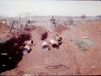The excavation for the new Special Forces mess hall.  The drum sections in the pit were used to build the escape tunnel down to the river.
